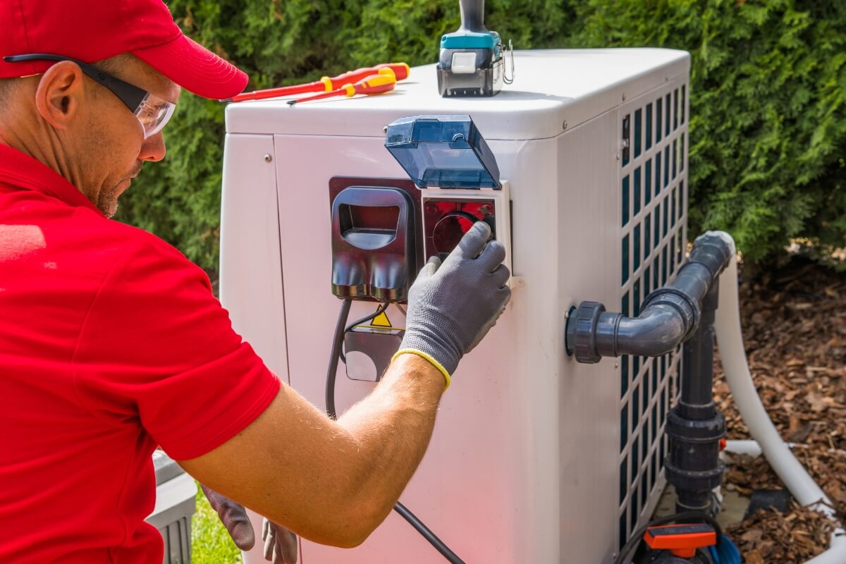 a person in red shirt working on an air conditioner