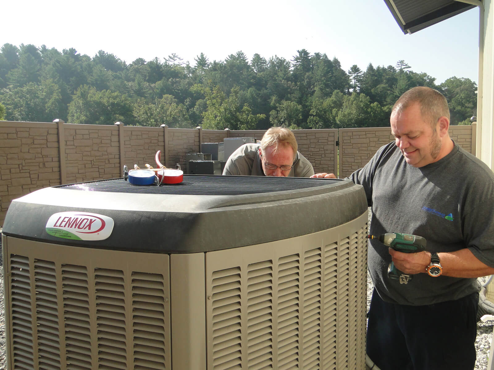 Two worker installing Lennox Outdoor Unit