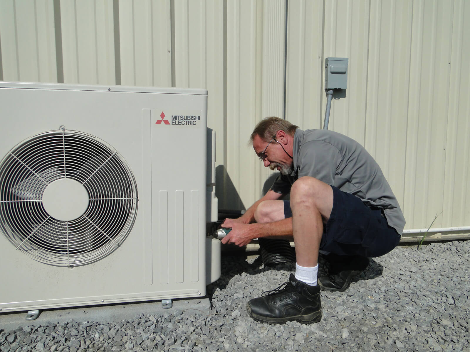 Worker Installing the Mitsubishi Outdoor Unit