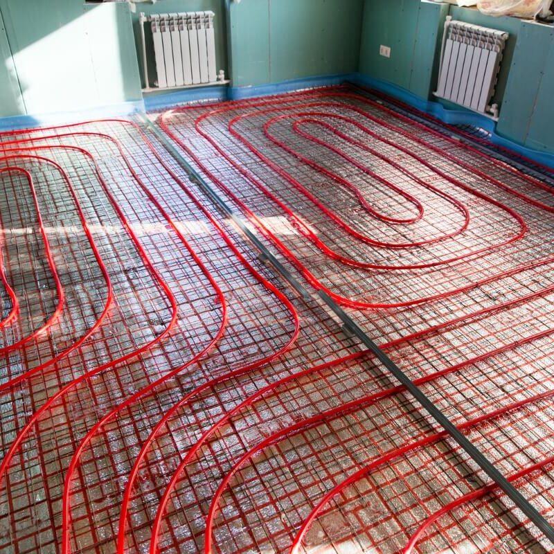a heated floor in a room with red pipes